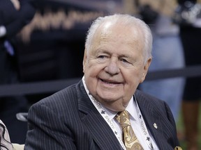 FILE - In this Oct. 26, 2014, file photo, New Orleans Saints owner Tom Benson sits on the sideline before the team's NFL football game against the Green Bay Packers in New Orleans. Visitation for Benson, who died last week, takes place Wednesday and Thursday at Notre Dame Seminary in New Orleans. A private funeral service is set for noon Friday at St. Louis Cathedral in the French Quarter.