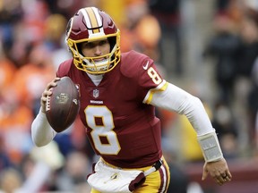 FILE - In this Dec. 24, 2017, file photo, Washington Redskins quarterback Kirk Cousins scrambles during an NFL football game against the Denver Broncos in Landover, Md. After agreeing to a trade to acquire quarterback Alex Smith, the Redskins are moving on from the Kirk Cousins era. When the league year opens in mid-March, Cousins will be the top free agent available and find no shortage of suitors for his services.