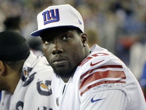 FILE - In this Aug. 31, 2017, file photo, New York Giants defensive end Jason Pierre-Paul watches from the sideline during the second half of an NFL preseason football game against the New England Patriots, in Foxborough, Mass. A person familiar with the deal says the Giants have traded defensive end Jason Pierre-Paul to the Tampa Bay Buccaneers for two draft picks. The person spoke on condition of anonymity Thursday, March 22, 2018,  because neither team has announced the deal that gets Tampa Bay the former first-round draft pick whose career was interrupted by a fireworks accident in 2015 that severely damaged his right hand.