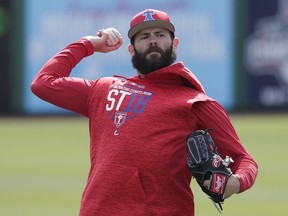 FILE - In this March 13, 2018, file photo, Philadelphia Phillies pitcher Jake Arrieta throws during a work out before a spring baseball exhibition game against the Tampa Bay Rays, in Clearwater, Fla.  When free-agent ace Jake Arrieta arrived at spring training on co-owner John Middleton's private plane, it signaled the start of a new era for this franchise.