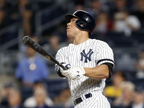 FILE - In this Sept. 18, 2017, file photo, New York Yankees' Aaron Judge (99) watches his first-inning, solo home run off Minnesota Twins starting pitcher Ervin Santana in a baseball game against the Twins in New York, Monday, Sept. 18, 2017. The Yankees reached Game 7 of last year's AL Championship Series behind Baby Bombers Judge, Gary Sanchez, Greg Bird and young ace Luis Severino. Then they added the mightiest slugger in the major leagues, Giancarlo Stanton, and brought in a new manager they think will lead them to World Series title No. 28.