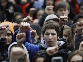FILE - In this Wednesday, March 14, 2018 file photo, demonstrators raise their fists in the air during a student-led march against gun violence at the Civic Center Plaza in San Francisco, one month after the deadly shooting inside a high school in Parkland, Fla. In numbers not seen since the tumult of the 1960s, multitudes are taking part in a surge of political and social activism. Their ranks include high school students angered by gun violence, teachers fed up with low pay, and women energized by a range of grievances _ notably pervasive sexual harassment and the longtime dominance of men in political power.