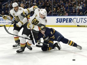 Vegas Golden Knights left wing Tomas Nosek (92) tries to get by Buffalo Sabres defenseman Casey Nelson (8) during the first period of an NHL hockey game, Saturday, March 10, 2018 in Buffalo, N.Y.