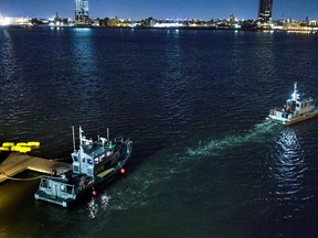 Yellow buoys that a New York police officer said were suspending a helicopter that crashed into the East River float next to a NYPD police boat at a pier in New York on Sunday, March 11, 2018. The helicopter crashed into New York City's East River Sunday night and flipped upside down in the water.