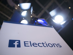 FILE- In this Aug. 6, 2015, file photo Facebook Elections signs stand in the media area in Cleveland before the first Republican presidential debate. The head of Trump-affiliated data-mining firm Cambridge Analytica was suspended on Tuesday, March 20, 2018, while government authorities are bearing down on both the firm and Facebook over allegations the firm stole data from 50 million Facebook users to manipulate elections.