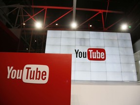 FILE - This Oct. 21, 2015, file photo shows signage inside the YouTube Space LA offices in Los Angeles.YouTube says it's cracking down on conspiracy videos, though it's scant on the details. YouTube CEO Susan Wojcicki said at a conference on Tuesday, March 13, 2018, that the company will work to debunk videos espousing conspiracy theories by including links to the online encyclopedia Wikipedia.