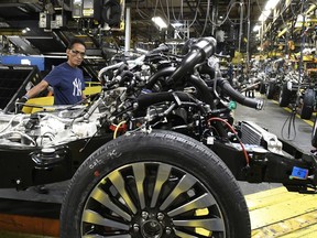 In this Oct. 27, 2017, photo, workers assemble Ford trucks at the Ford Kentucky Truck Plant in Louisville, Ky. On Thursday, March 1, 2018, The Institute for Supply Management, a trade group of purchasing managers, issues its index of manufacturing activity for February.