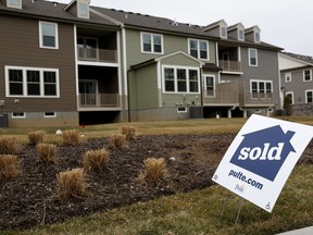 FILE- In this Monday, Feb. 26, 2018, file photo, sold signs are displayed in front of a new development in Woodcliff Lake, N.J. Freddie Mac reports on the week's average U.S. mortgage rates on Thursday, March 8.