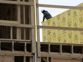 FILE- In this Monday, Feb. 26, 2018, photo, work continues on a new development in Fair Lawn, N.J. On Friday, March 9, the Labor Department reported that U.S. employers added 313,000 jobs in February, the most in any month since July 2016, and drawing hundreds of thousands of people into the job market.
