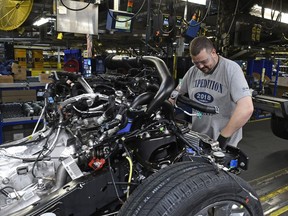 FILE- In this Oct. 27, 2017, file photo, workers assemble Ford trucks at the Ford Kentucky Truck Plant in Louisville, Ky. On Friday, March 16, 2018, the Federal Reserve reports on U.S. industrial production for February.