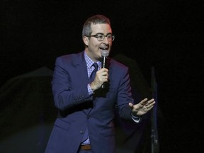 FILE - In this Nov. 7, 2017 file photo, comedian John Oliver performs at the 11th Annual Stand Up for Heroes benefit in New York. Oliver has trolled his way to the top. The HBO host's spoof of a new picture book by the wife and daughter of Vice President Mike Pence was No. 1 on Amazon.com as of midday Monday, March 19, 2018.