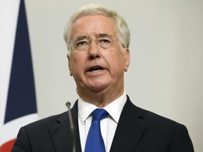 FILE - In this Oct. 12, 2017, file photo, Britain's Defense Secretary, Michael Fallon, addresses members of the media during a joint UK/Poland press conference in the Foreign and Commonwealth Office in London. Harassment allegations last year led to Fallon's resignation and prompted political leaders to propose a new grievance procedure for people working in Parliament.
