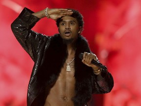 FILE - In this June 25, 2017 file photo, Trey Songz performs at the BET Awards at the Microsoft Theater in Los Angeles. Police say the R&B singer has been arrested on suspicion of felony domestic violence for punching a woman at a Los Angeles party.  LAPD spokesman Officer Drake Madison says the 33-year-old whose real name is Tremaine Neverson turned himself in at a Hollywood police station Monday morning, March 19, 2018. Jail records show Songz was released about two hours later on $50,000 bail.