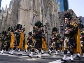 Bagpipers with the NYPD Emerald Society walks past St. Patrick's Cathedral as they take part in the St. Patrick's Day parade Saturday, March 17, 2018, in New York.  Irish Prime Minister Leo Varadkar joined along as Manhattan's Fifth Avenue came alive with the sound of bagpipes, trumpets and lots of green during the 257th running of the parade.