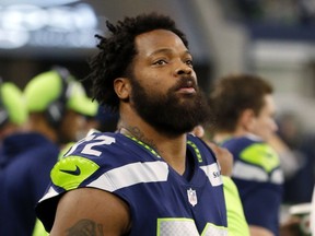 FILE - In this Dec. 24, 2017, file photo, Seattle Seahawks defensive end Michael Bennett (72) watches his team play the Dallas Cowboys during an NFL football game in Arlington, Texas. A Harris County, Texas, grand jury on Friday, March 23, 20187, indicted Philadelphia Eagles defensive end Michael Bennett on a felony count of injury to the elderly for injuring a 66-year-old paraplegic who was working at NRG Stadium in Houston to control access to the field at Super Bowl 51, prosecutors said. The Eagles earlier this month acquired Bennett from the Seahawks.
