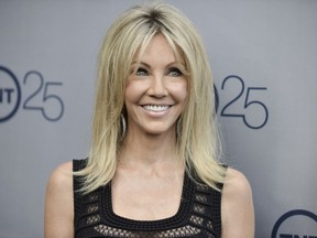 FILE - In a July 24, 2013 file photo, Heather Locklear arrives at the TNT 25th Anniversary Party at The Beverly Hilton Hotel in Los Angeles. Locklear has been charged with several counts of battery against first responders who answered a domestic violence call at her Southern California home. The 56-year-old "Melrose Place" actress was charged Monday, March 12, 2018, with four misdemeanor counts of battery on an officer or emergency personnel, and one misdemeanor count of resisting or obstructing an officer.