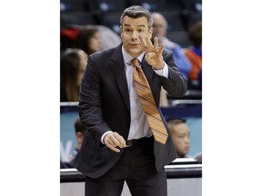 Virginia head coach Tony Bennett calls out to his team during the first half of an NCAA college basketball game against Louisville in the quarterfinal round of the Atlantic Coast Conference tournament Thursday, March 8, 2018, in New York.
