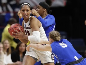 South Carolina's A'ja Wilson (22) looks to pass away from Buffalo's Katherine Ups (5) during the second half in a regional semifinal at the NCAA women's college basketball tournament Saturday, March 24, 2018, in Albany, N.Y. South Carolina won 79-63.