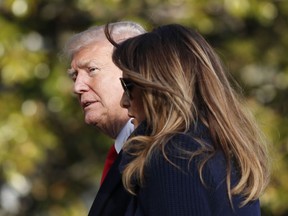 In this March 19, 2018, photo, President Donald Trump, accompanied by first lady Melania Trump, walks on the South Lawn of the White House in Washington, on his return from a trip to New Hampshire. Former Playboy model Karen McDougal apologized to Melania Trump for a 10-month affair she claims she had with President Trump that started with him offering her money after the first time they had sex.