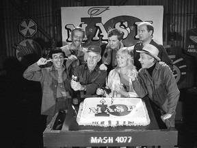 FILE - In this Oct. 22, 1981, file photo, Jamie Farr, from front left, plugs his ears as cast members of the "M.A.S.H." television series cast Harry Morgan, Loretta Swit, William Christopher and, from back from left, Mike Farrell, Alan Alda and David Ogden Stiers celebrate during a party on the set of the popular CBS program in Los Angeles. Stiers a prolific actor best known for playing a surgeon on the television series "M.A.S.H." has died, the actor's agent Mitchell Stubbs confirmed Saturday night, March 4, 2018, in an email. He was 75.