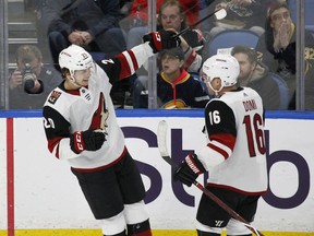 Arizona Coyotes Dylan Strome (20) and Max Domi (16) celebrate a goal during the first period of the team's NHL hockey game against the Buffalo Sabres on Wednesday, March 21, 2018, in Buffalo, N.Y.