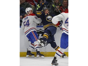 Buffalo Sabres' Casey Nelson (8) and Montreal Canadiens' Charles Hudon (54) collide during the first period of an NHL hockey game Friday, March 23, 2018, in Buffalo, N.Y.