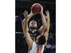 Notre Dame forward Martinas Geben (23) shoots against Virginia Tech guard Devin Wilson (11) during the first half of an NCAA college basketball game in the second round of the Atlantic Coast Conference men's tournament Wednesday, March 7, 2018, in New York.