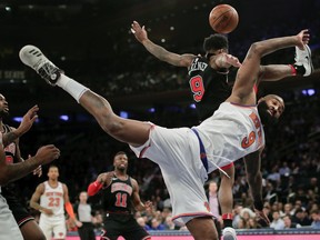 New York Knicks center Kyle O'Quinn (9) is fouled by Chicago Bulls guard Antonio Blakeney (9) during the second quarter of an NBA basketball game, Monday, March 19, 2018, in New York.