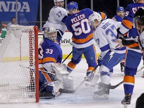 New York Islanders goaltender Christopher Gibson (33) watches the puck slip across the goal line for a goal by Tampa Bay Lightning center Anthony Cirelli during the first period of an NHL hockey game, Thursday, March 22, 2018, in New York.