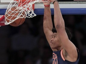 New York Knicks forward Isaiah Hicks (4) dunks against the Charlotte Hornets during the second quarter of an NBA basketball game, Saturday, March 17, 2018, in New York.