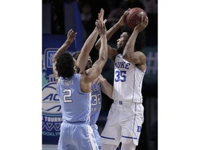 Duke forward Marvin Bagley III (35) looks for a shot against North Carolina guard Joel Berry II (2) and forward Luke Maye (32) during the first half of an NCAA college basketball game in the Atlantic Coast Conference men's tournament semifinals Friday, March 9, 2018, in New York.