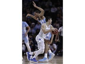 Duke guard Grayson Allen (3) drives around North Carolina forward Garrison Brooks during the first half of an NCAA college basketball game in the Atlantic Coast Conference men's tournament semifinals Friday, March 9, 2018, in New York.