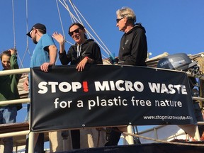 In this Oct. 15, 2017, photo provided by Alexander Nolte, Marta Delgado, center, and Joseph Dillard, right, participate in an event to raise awareness about microfiber pollution in the environment in Amsterdam, Netherlands. Innovators are coming up with new tools to prevent tiny pieces of threads from entering waterways after the laundry and reaching marine life.