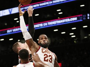 Cleveland Cavaliers forward LeBron James (23) tips the ball away from Brooklyn Nets forward Joe Harris, uppeer left, and tries to tip it to Cavaliers center Tristan Thompson (13) during the second half of an NBA basketball game, Sunday, March 25, 2018, in New York. The Cavaliers defeated the Nets 121-114.