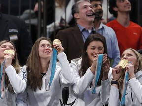 Several members of the USA women's hockey team clown around with their gold medals as they watch the Tie Break Tens tennis tournament at Madison Square Garden, Monday, March 5, 2018 in New York. The Tie Break Tens' New York event is a one-day day exhibition tournament featuring eight female players competing for a $250,000 winner's prize.