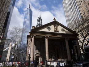 In this March 16, 2018, photo, One World Trade Center towers above St. Paul's Chapel in New York. Two New York City churches that survived the destruction of World Trade Center have become the latest city tourist sites to embrace post-9/11 security measures. Metal detectors were installed for the first time this month at Trinity Church and St. Paul's Chapel.