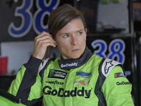 FILE - This Feb. 17, 2018 file photo shows Danica Patrick preparing for practice for the NASCAR Daytona 500 Cup Series auto race at Daytona International Speedway in Daytona Beach, Fla. Patrick is ready for the final leg of her "Danica Double" and will get fitted for her Indianapolis 500 seat next week. She will drive in the May race for Ed Carpenter Racing. Her first time back in an Indy car will be at the end of this month during a test session for Chevrolet at Indianapolis 500. Patrick shunned the superstitious avoidance of the number 13 and will drive it at Indy for Carpenter.