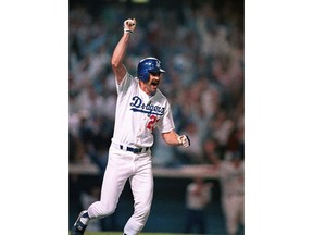 FILE - In this Oct. 15, 1988, file photo, Los Angeles Dodgers' Kirk Gibson celebrates as he rounds the bases after hitting a game-winning two-run home run in the bottom of the ninth inning to defeat the Oakland Athletics 5-4 in the first game of the World Series, at Dodger Stadium in Los Angeles. The Dodgers will pay tribute to one of baseball's most celebrated home runs by introducing a "Kirk Gibson seat" in right field at Dodger Stadium.