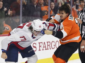 FILE  - This March 18, 2018 file photo shows Washington Capitals' T.J. Oshie, left, fighting Philadelphia Flyers' Travis Konecny during the third period of an NHL hockey game in Philadelphia. A tight race among contenders in the Metropolitan Division should have the top five teams battle-tested and playoff-ready. The Washington Capitals, Pittsburgh Penguins, Philadelphia Flyers, Columbus Blue Jackets and New Jersey Devils could all make it and are already in playoff mode. And the Metropolitan playoff series should be as tight as this season.