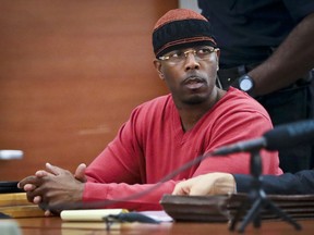 FILE - In this May 5, 2017, photo file photo, Calvin Buari listens during a hearing at Bronx Criminal Court to vacate his double murder conviction, in New York. Prosecutors dropped charges Wednesday, March 21, 2018, against Buari who spent 22 years in prison for a double killing before new witnesses came forward and his conviction was overturned.