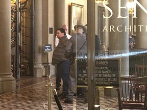 This photo provided by Sean Ewart shows New York Daily News reporter Ken Lovett being handcuffed and taken into custody by state police after a Senate sergeant-at-arms observed him speaking on his cellphone in the lobby, outside the Senate chambers in the state Capitol, Albany, N.Y., Wednesday, March 28, 2018. Lovett was arrested Wednesday for violating a cellphone ban in the lobby of the New York state Senate, only to be quickly released by Gov. Andrew Cuomo.