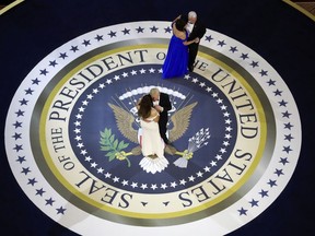 FILE - In this Jan. 20, 2017, file photo, President Donald Trump and First Lady Melania Trump are joined by Vice President Mike Pence and his wife Karen for a dance on a large presidential seal at the Salute to Armed Forces Ball for President Donald Trump at the National Building Museum in Washington. The Trump Organization says Tuesday, March 6, 2018, that replicas of the presidential seal displayed at one of its golf clubs were given to the company by club members and have since been removed.