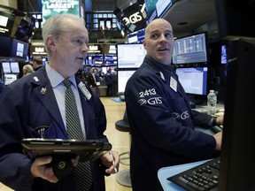 Trader James Riley, left, and specialist John O'Hara work on the floor of the New York Stock Exchange, Friday, March 16, 2018. Global stock markets were mixed Friday amid caution about U.S. plans to raise tariffs on imports of steel and aluminum and uncertainty over White House politics.