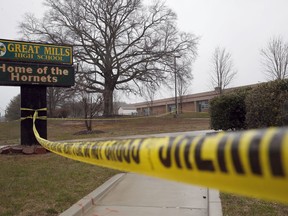 FILE - This Tuesday, March 20, 2018, file photo, shows crime scene tape around Great Mills High School, the scene of a shooting in Great Mills, Md. In a statement released Monday, March 26, 2018, authorities said the student who fatally shot a female classmate at the school died from a self-inflicted gunshot wound.