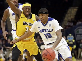 FILE - In this Saturday, March 10, 2018, file photo, Buffalo's Wes Clark (10) drives past Toledo's Marreon Jackson (3) during the second half of an NCAA college basketball championship game of the Mid-American Conference tournament, in Cleveland. Clark went from his college career being stuck in limbo over a two-year span to helping the University at Buffalo win the Mid-American Conference championship and secure its third NCAA Tournament berth in four years.