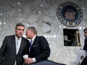 FILE - In this Tuesday, Feb. 13, 2018, file photo, Vice Chairman Mark Warner, D-Va., left, and Chairman Richard Burr, R-N.C., speak following a Senate Select Committee on Intelligence hearing on worldwide threats, in Washington. With the 2018 primary season already underway, Burr and Warner are launching an effort to protect U.S. elections from a repeat episode of foreign interference. The two will preview some of the Senate Intelligence Committee's recommendations for improving the nation's election infrastructure at a news conference Tuesday, March 20, 2018.