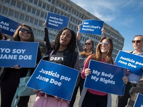 FILE - In this Friday, Oct. 20, 2017, file photo, activists with Planned Parenthood demonstrate in support of a pregnant 17-year-old being held in a Texas facility for unaccompanied immigrant children to obtain an abortion, outside of the Department of Health and Human Services in Washington. A federal court in Washington told the Trump administration Friday, March 30, 2018, that the government can't interfere with the ability of pregnant immigrant teens being held in federal custody to obtain abortions.