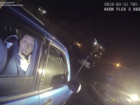 In this screen grab from body camera video provided by the Louisville Metro Police Department, Elijah Eubanks talks to a police officer from the passenger side of a car, early Saturday, March 31, 2018, in Louisville, Ky. Moments later, Eubanks was shot and wounded after police say he fired a revolver at the officer. (Louisville Metro Police Department via AP)