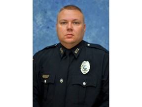 This photo provided by the Kentucky State Police shows  Officer Phillip Meacham. The off-duty police officer was shot and killed Thursday, March 29, 2018, in  Hopkinsville, Ky., and authorities were searching for a suspect who fled in a stolen truck, Kentucky State Police said. (Kentucky State Police via AP)