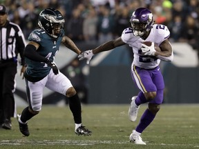 File-This Jan. 21, 2018, file photo shows Minnesota Vikings' Jerick McKinnon running past Philadelphia Eagles' Ronald Darby during the first half of the NFL football NFC championship game in Philadelphia. The 49ers agreed to a four-year contract with versatile running back McKinnon and a five-year deal with interior offensive lineman Weston Richburg on Wednesday, March 14, 2018 just after the start of the new league year. McKinnon will replace starter Carlos Hyde, who was allowed to leave in free agency.